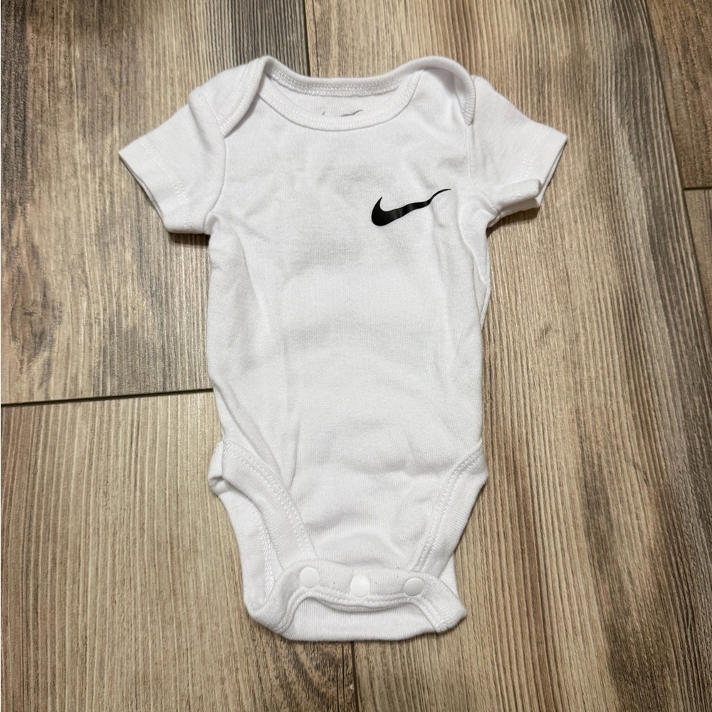 Nike White Baby Bodysuit with Black Swoosh